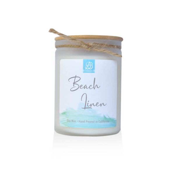 A candle with the word beach linen on it.