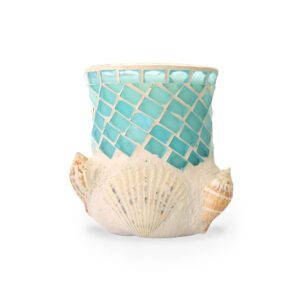 A sea glass candle holder with sea shells on it.