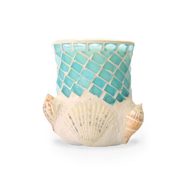 A sea glass candle holder with sea shells on it.