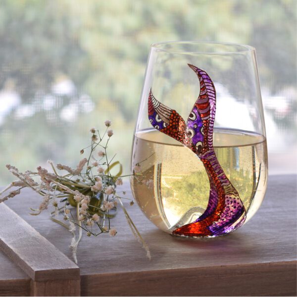 A stemless Merlot glass with a mermaid tail on it.