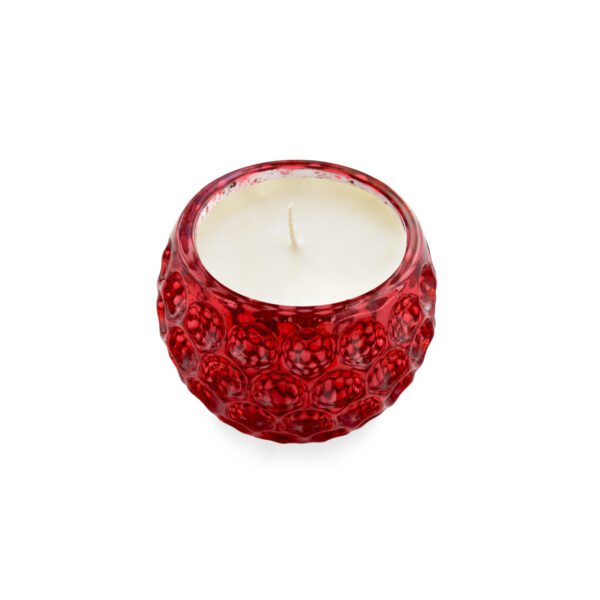 A red glass candle on a white background.