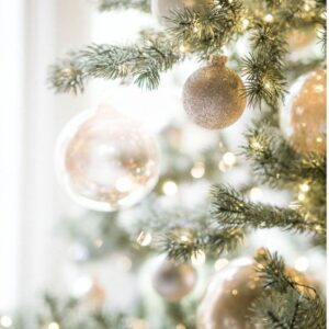 A christmas tree decorated with gold and silver ornaments.