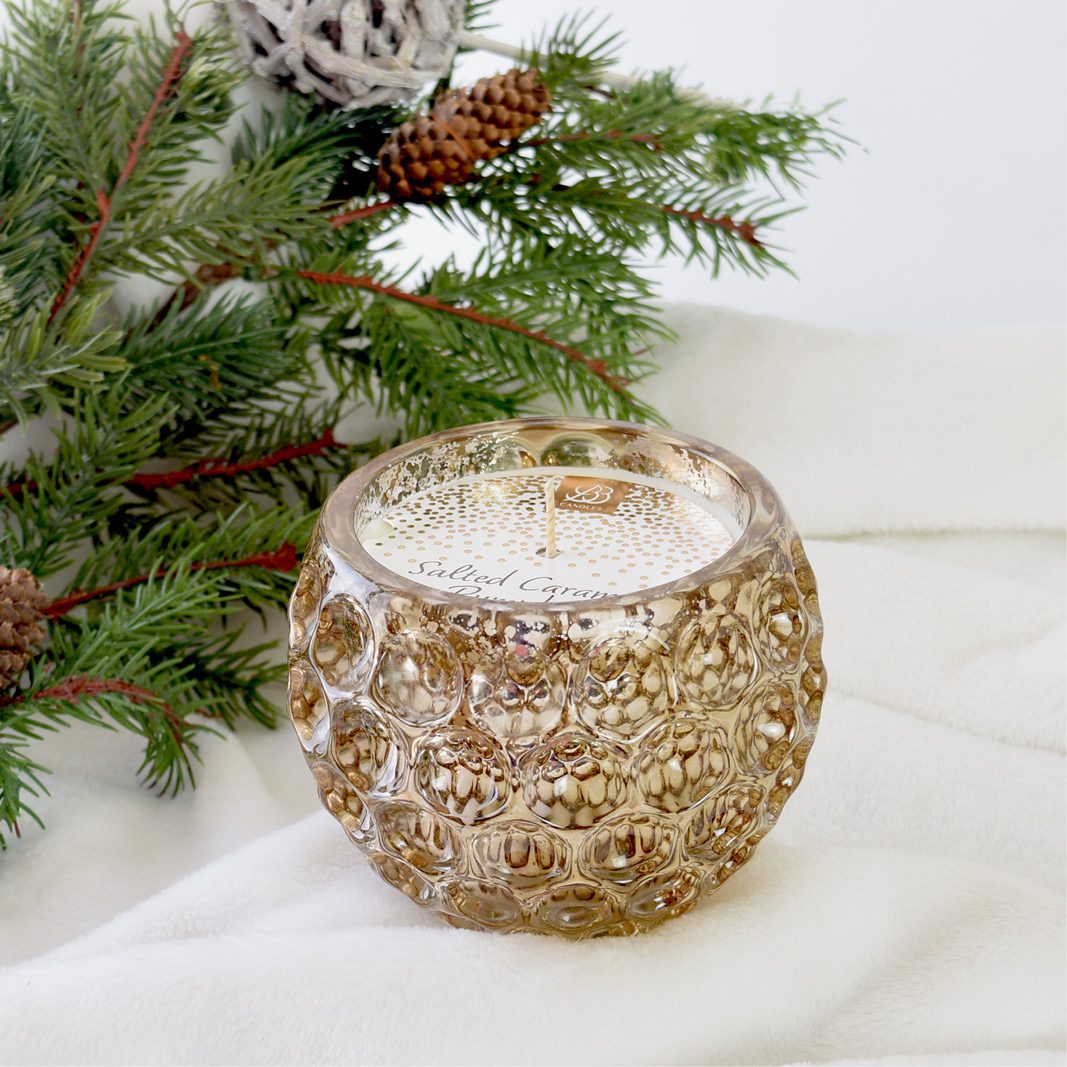 luxury mercury bronze glass candle with a holiday background