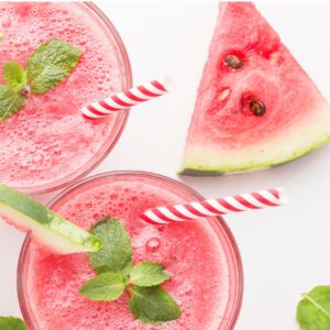 Two glasses of watermelon smoothie with mint leaves.