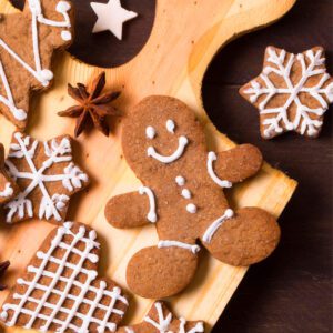 Gingerbread cookies on a wooden cutting board.