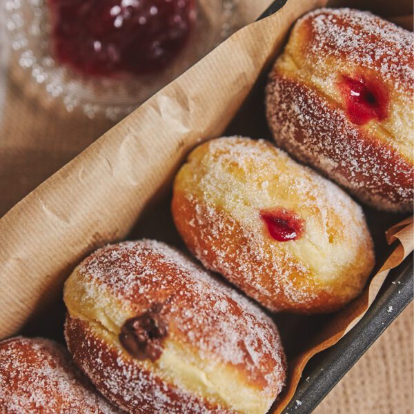 Donuts with jam and powdered sugar.